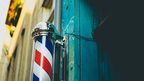 barber close-up photography of gray stainless steel dispenser sign